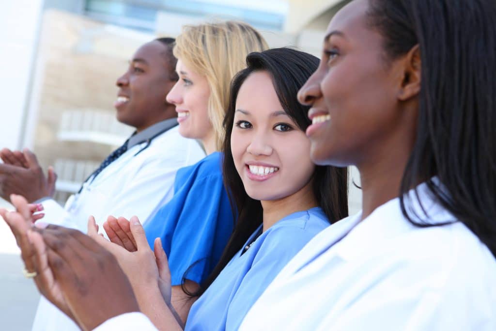 Diverse medical team smiling after receiving NHA certification