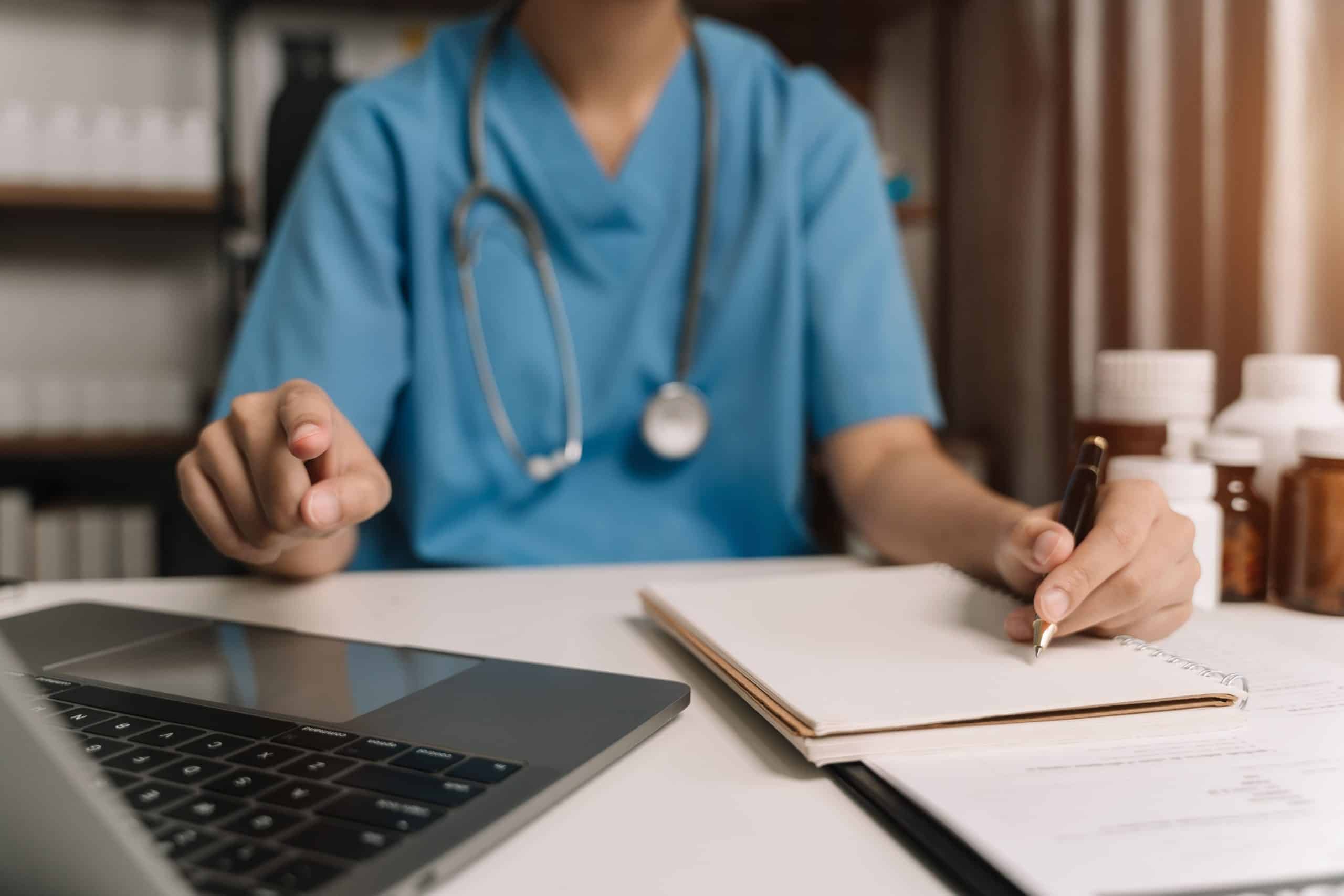 Nurse writing in notepad